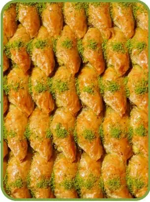 Şöbiyet — syrup-soaked filo baklava filled with cream and pistachio.