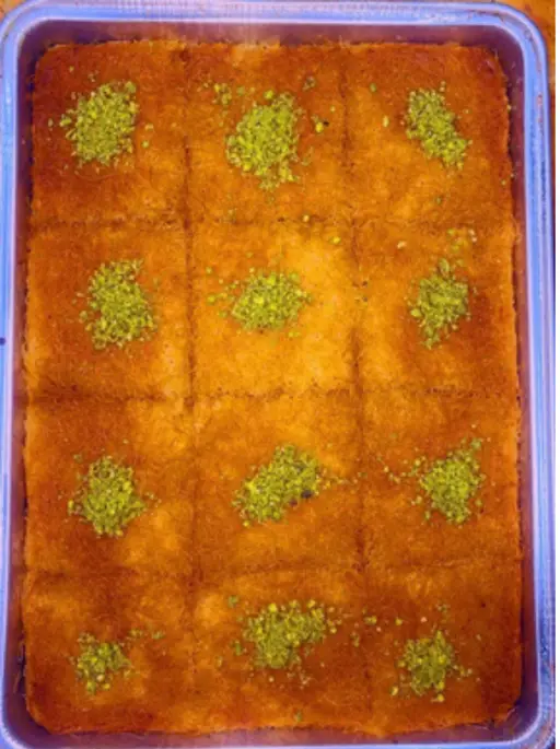 Kunafa with pistachio — shredded kataifi pastry in syrup, cut into pieces.