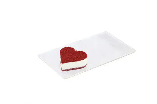 Heart-shaped red velvet mono cake with white cream filling.