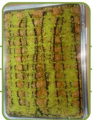 Chocolate burma — rolled pastry with chocolate, topped with pistachio.