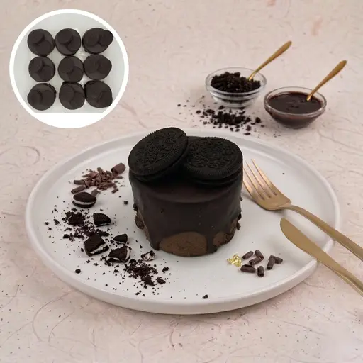 Oreo mono cake layered with cream and chocolate, topped with chocolate shavings.