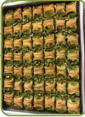 Yüzük (ring) baklava topped with pistachio.
