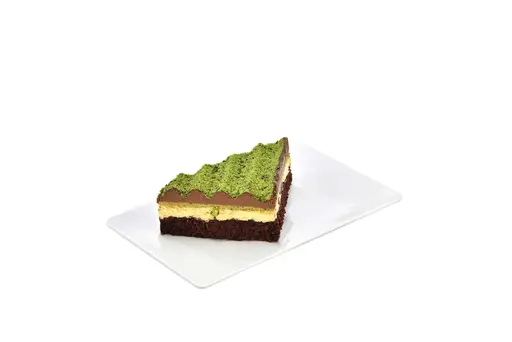 Layered pistachio cake with chocolate and cream.