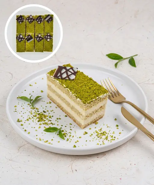Layered pistachio slice cake with cream.