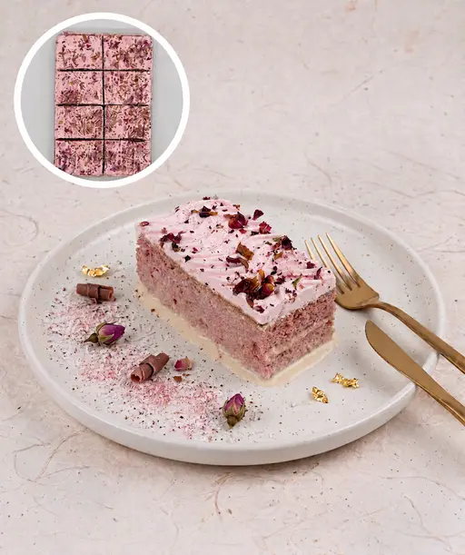 Tres leches (trilece) milk cake topped with rose-flavoured cream and dried rose petals.