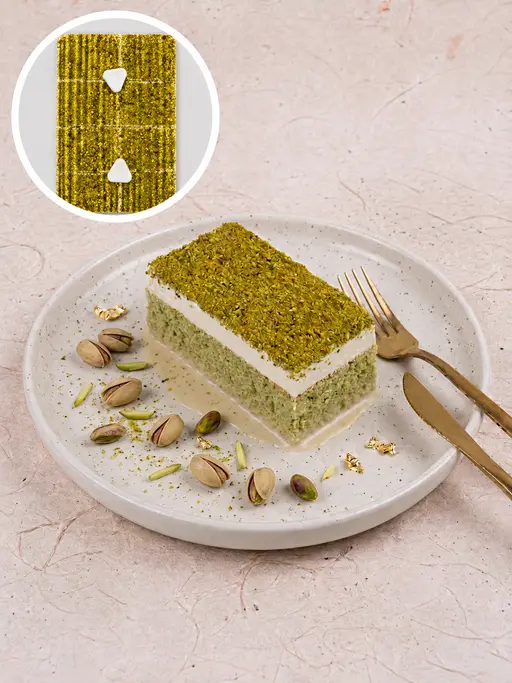 Tres leches (trilece) milk cake topped with pistachio cream and crushed pistachios.