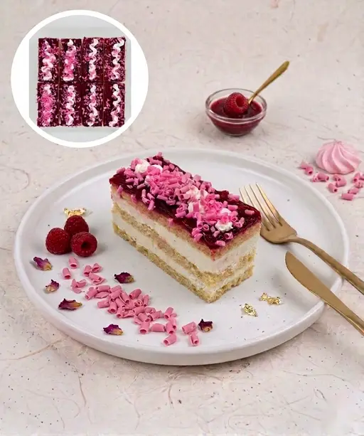Layered slice cake with cream and raspberry.