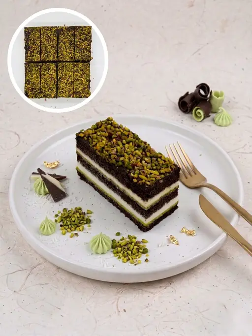 Layered pistachio cream and chocolate slice cake.