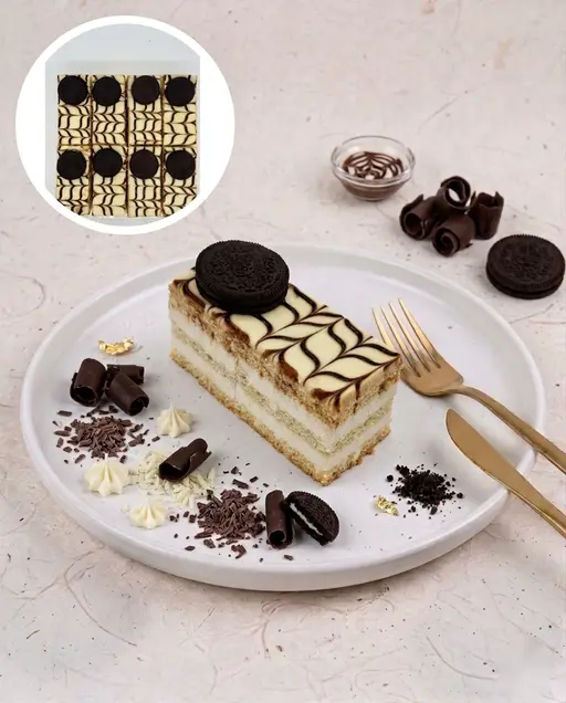 Layered white chocolate slice cake topped with Oreo.