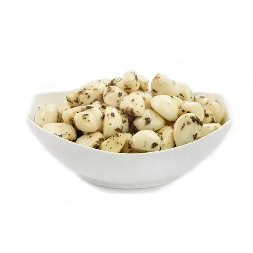 Pickled garlic cloves with herbs in oil.