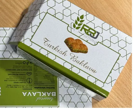 White and green presentation carton for baklava with a honeycomb design.
