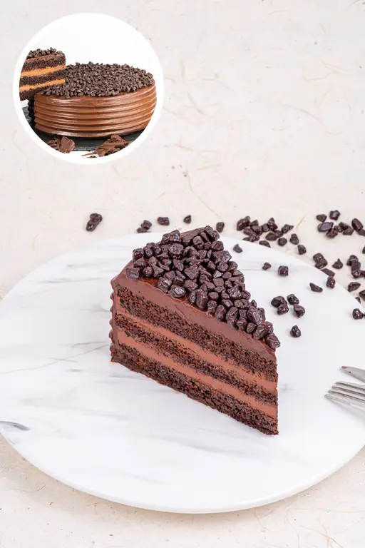 Layered Belgian chocolate cake topped with chocolate chunks.
