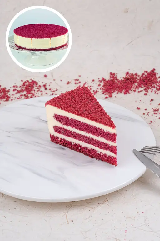 Layered red velvet cake with white cream filling.