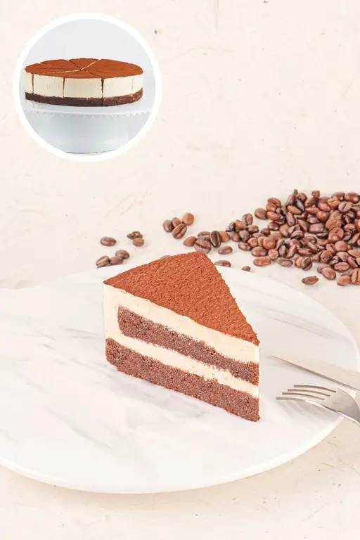 Layered tiramisu cake dusted with cocoa.