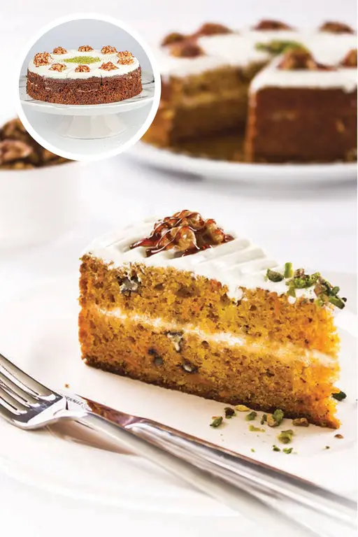 Layered carrot cake with cream filling and a glazed top.