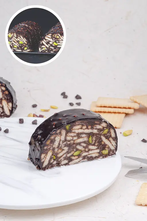 Chocolate mosaic cake with biscuit pieces and pistachios.