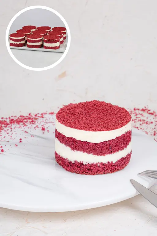 Red velvet mono cake with layers of red sponge and white cream.
