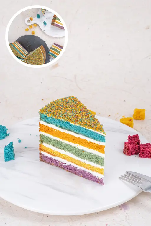 Colourful rainbow layer cake with sprinkles.